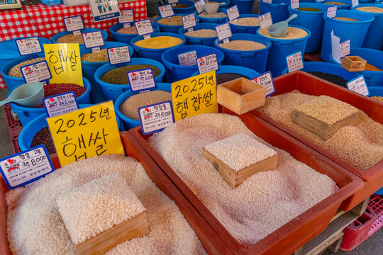 View of produce stall in Haean Market at Chungmudong on street with signs on a sunny day, Chungmu-daero, Seo-gu, Busan, South Korea