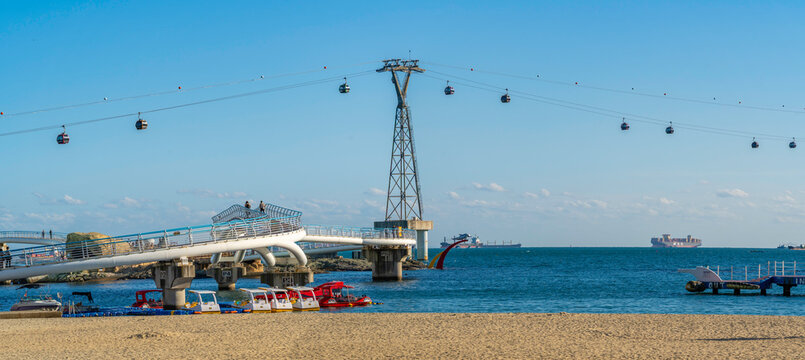 View of Songdo Beach and Songdo Cable Car in background on a sunny day, Busan, South Korea