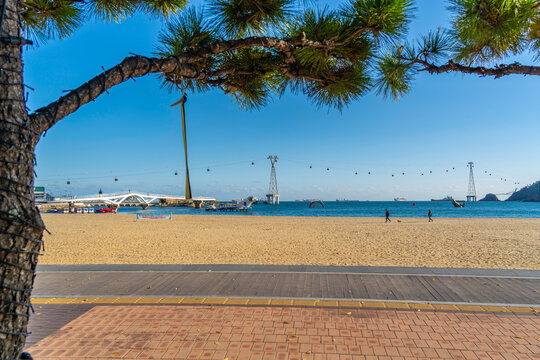 View of Songdo Beach and Songdo Cable Car in background on a sunny day, Busan, South Korea