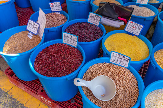 View of produce stall in Haean Market at Chungmudong on street with signs on a sunny day, Chungmu-daero, Seo-gu, Busan, South Korea