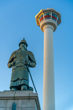 View of Busan Tower and Statue of Admiral Yi Sun-sin in Yongdusan Park at sunset, Busan, South Korea