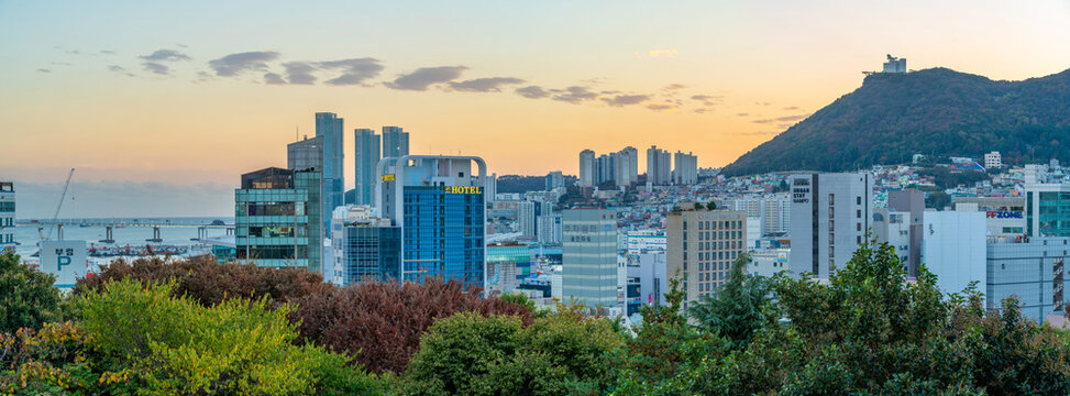 View of city skyline at sunset from Yongdusan Park, Busan, South Korea