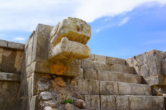 Ancient Maya Serpent Head Stone Sculpture and Temple Ruins at Chichen Itza Archaeological Site, Yucatan, Mexico