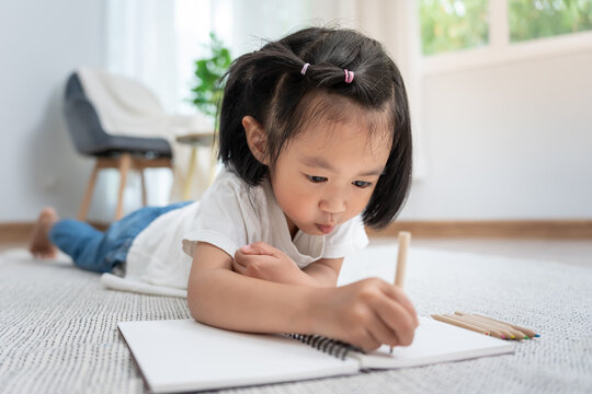 Happy Asia children playing learning paint on paper. Activity, development, IQ, EQ, meditation, brain, muscles, essential skills, family having fun spending time together. Holiday