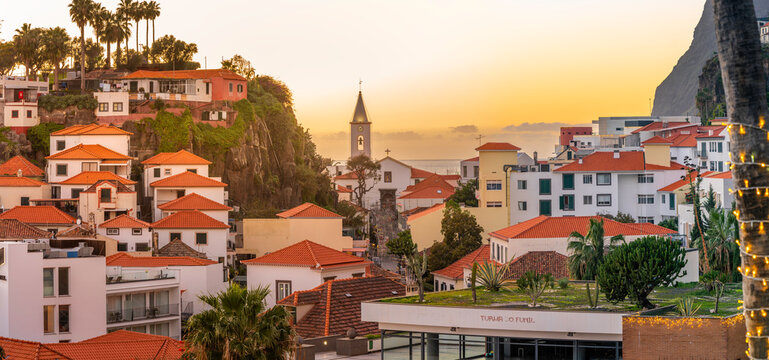 Elevated view of Igreja Matriz de Sao Sebastiao church and Camara de Lobos at sunset, Funchal, Madeira, Portugal