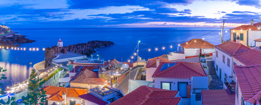 Elevated view of harbour and Camara de Lobos at dusk, Funchal, Madeira, Portugal