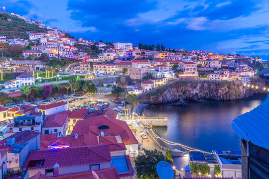 Elevated view of harbour and Camara de Lobos at dusk, Funchal, Madeira, Portugal