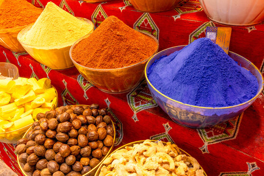 Explore spices from local merchants in vibrant bowls at the market in Muscat, Oman
