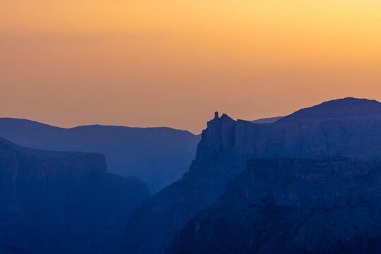 Vivid sunset colors at Dianas Viewpoint in Jabal Akhdar with mountain silhouettes