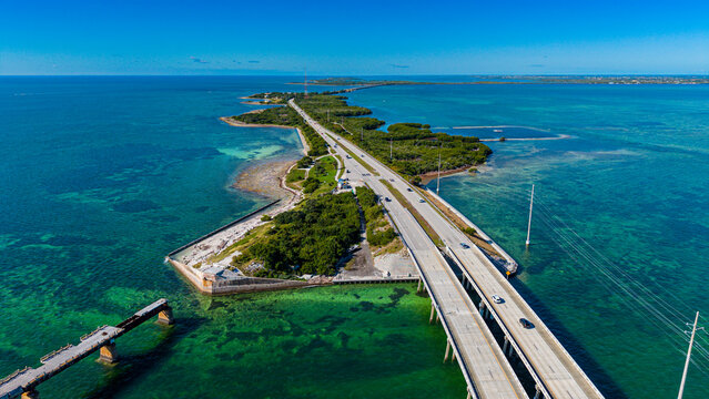 Aerial view of Highway Number 1 crossing over clear waters with vehicles traveling in Florida Keys region