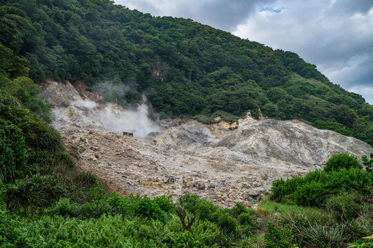 Visit to a sulfur spring with steam rising from the ground near the volcanic area in Saint Lucia