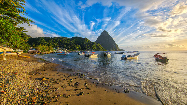 View of boats on the beach with the Pitons in the background during sunset in Soufriere, Saint Lucia