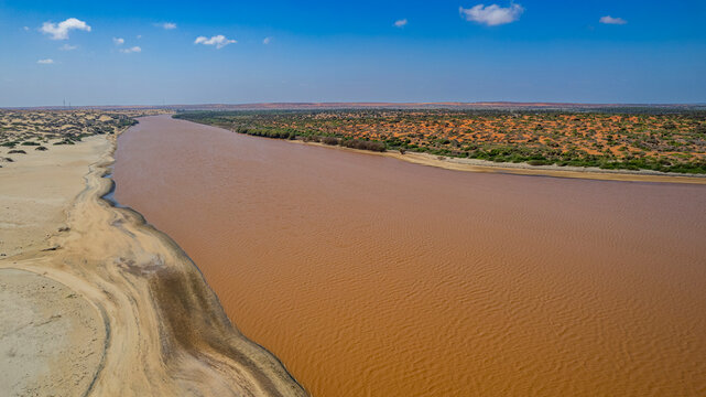 Aerial view of the Juba river flowing into the Indian Ocean near Kismayo in Jubaland, Somalia