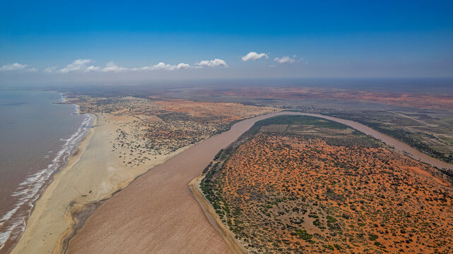 Juba river meets Indian Ocean in Kismayo region of Somalia with sandy shores and green landscape