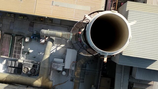 Close Up Aerial View of Industrial Chimney Smoke Stack with Heat Haze and Emissions in Harlow UK