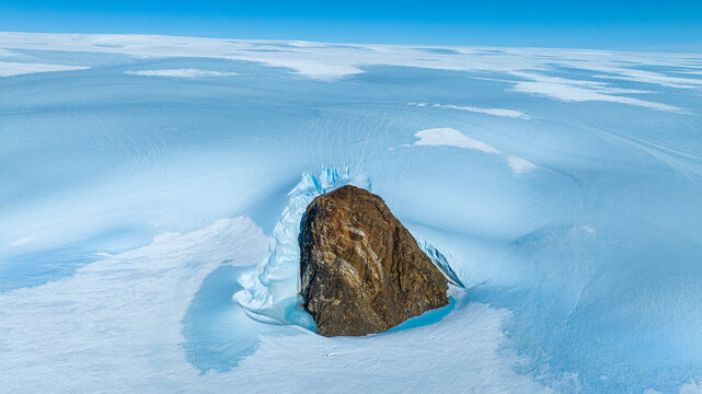 Aerial of the top of a mountain standing out of a glacier, Queen Maud Land, Antarctica