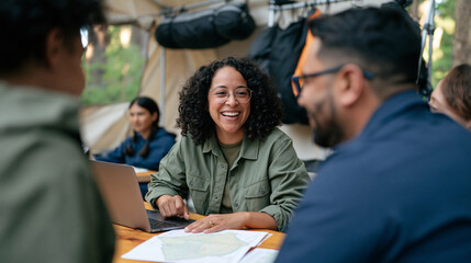 Fototapeta premium Email marketing specialist at a forest coworking retreat photographed in a multicultural team huddle around a pine table, laptops open beside topographic maps, natural outdoor