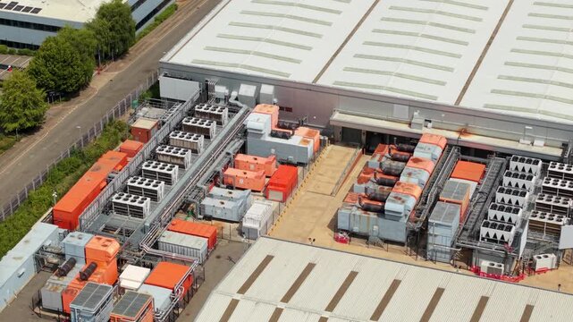 Close Up Aerial View of Industrial Data Center Cooling Units and Backup Power Generators in the UK
