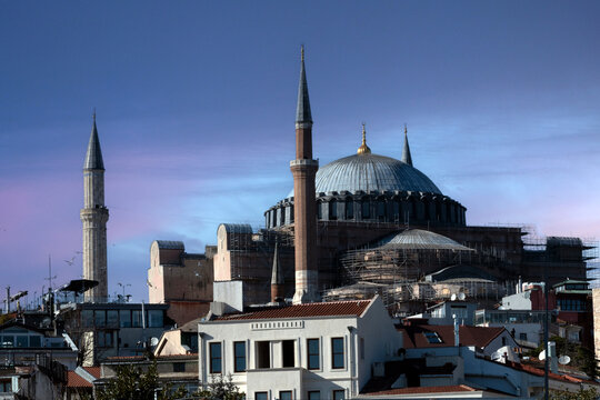 Hagia Sophia Mosque stands tall with construction works in progress, visiting tourists gather around the iconic landmark in the heart of Istanbul