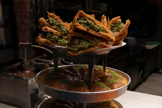 Traditional pistachio cakes are arranged on display in a dessert shop in Istanbul, Turkey during the bustling hours of the day