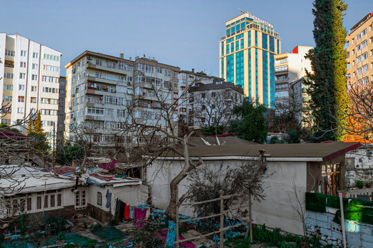 Modern skyscrapers rise above older residential buildings in Istanbul highlighting urban development and change in the city landscape