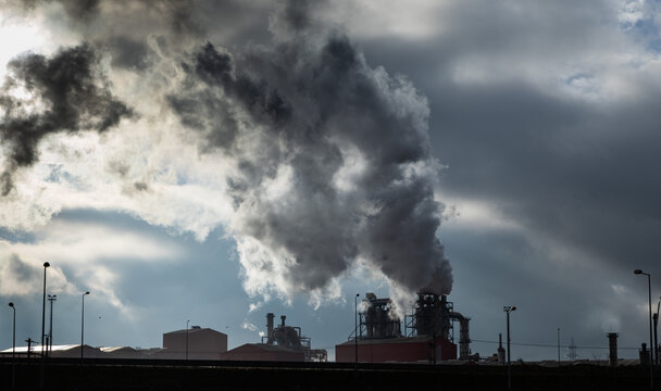 Smoke rises from factory chimneys contributing to pollution in Romania's industrial landscape