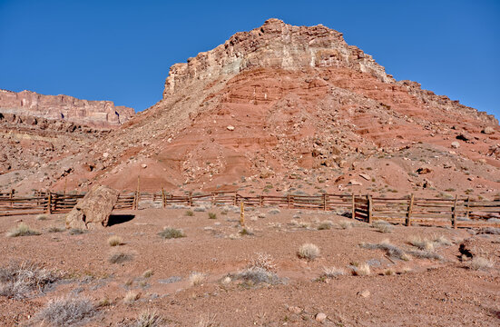 Old corral remains from pioneer days in Soap Creek Wilderness with red rock backdrop in Arizona