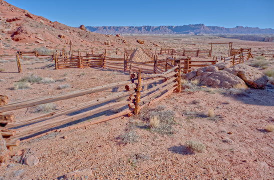 Old corral from the pioneer era in Soap Creek Wilderness with rugged landscape in background during daylight hours