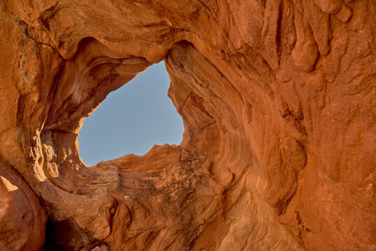 Rock window framed by canyon walls near Soap Creek offers a view of the sky in Vermilion Cliffs National Monument Arizona