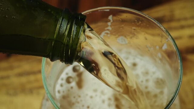 Close-up of Golden Beer Filling a Glass Pitcher with Frothy Foam 
