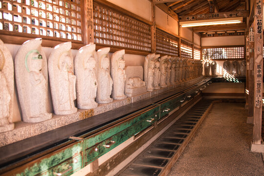 Hallway of stone statues at Katsuo-ji Temple representing the 88 temples of the Shikoku Pilgrimage in Japan