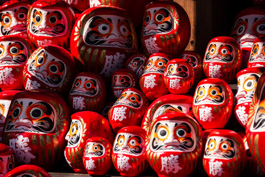 Daruma dolls stacked in Minoh temple offer hope for success and perseverance