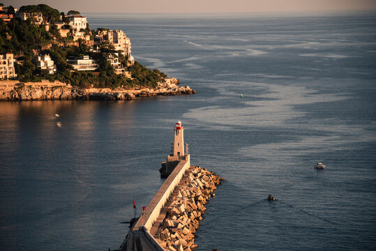 View of Nice lighthouse at the end of the harbor jetty marking the entrance to the Port of Nice in France
