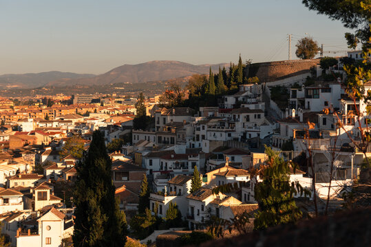 View of rooftops in Albaicin highlighting the historic Moorish architecture near Mirador San Crisobal in Granada, Spain during sunset