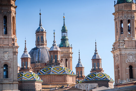 Detail of Basilica del Pilar domes and towers with colorful tiles on the banks of the Ebro River in Zaragoza, Spain