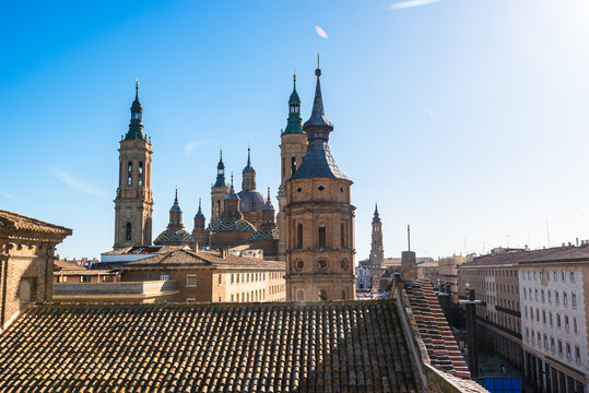 Rooftop view reveals Basilica del Pilar and La Seo Cathedral in morning sun over Zaragoza