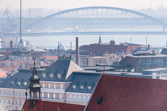 View of Bratislava rooftops with Apollo Bridge over Danube River in distance from Old Town perspective in Slovakia