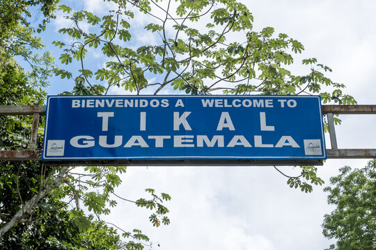 Bilingual welcome sign at the entrance of Tikal national park greets visitors to ancient Maya city in Guatemala