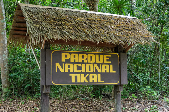 Wooden sign with thatched roof welcomes visitors to national park and Maya ruins in Mesoamerica