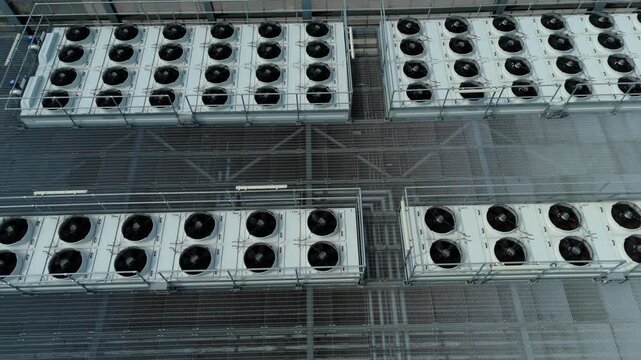 Close Up Aerial View of Large Rooftop HVAC Cooling Fans and Ventilation Systems on Modern Data Center