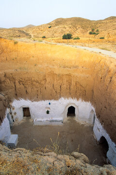 Cave dwelling with circular structure in arid landscape of North Africa near Matmata in Tunisia