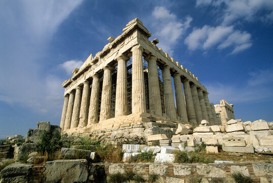 Ancient columns of the Parthenon stand against a partly cloudy sky in Athens, Greece, highlighting classical architecture and history