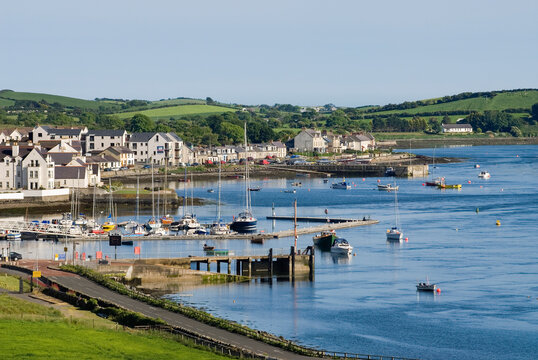 Harbor with boats and homes near water in Portaferry, Northern Ireland, on a clear day