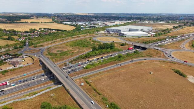 Aerial Hyperlapse of Heavy Traffic Flowing Through Busy Motorway Junction and Roundabout Interchange