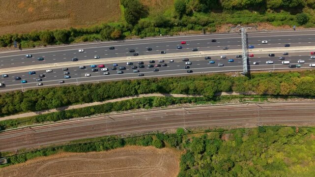 Top down aerial view of busy M1 motorway traffic and battery energy storage system in Luton UK