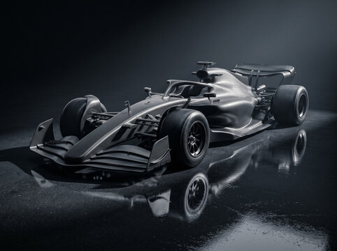 black carbon formula car with full reflection on wet dark studio floor viewed from front side angle