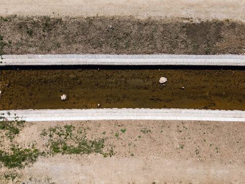 The design of river management with raised embankments and reinforced waterways to reduce flood risk.