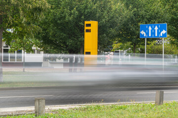 Fotoradar przy drodze i szybko poruszające się samochody