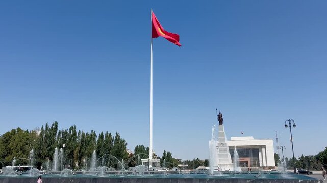 Ala-Too Square in Bishkek, Kyrgyzstan, features a central monument of the epic hero Manas on horseback, alongside the nation's official flagpole and honor guard