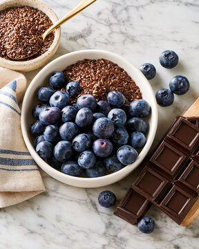 Elegant flat lay of blueberries flaxseed and dark chocolate highlighting perimenopause cognitive wellness and brain nutrition